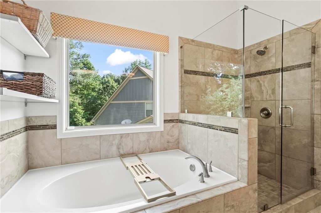 183 Lullwater Lane Dallas, GA 30132 - Photo 23 of 40 a bathroom with a tub and a shower