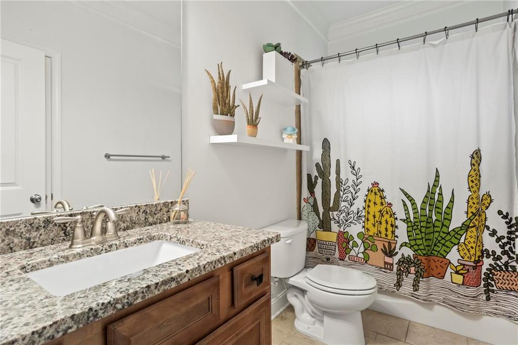 183 Lullwater Lane Dallas, GA 30132 - Photo 26 of 40 a bathroom with a granite countertop sink a toilet and a mirror