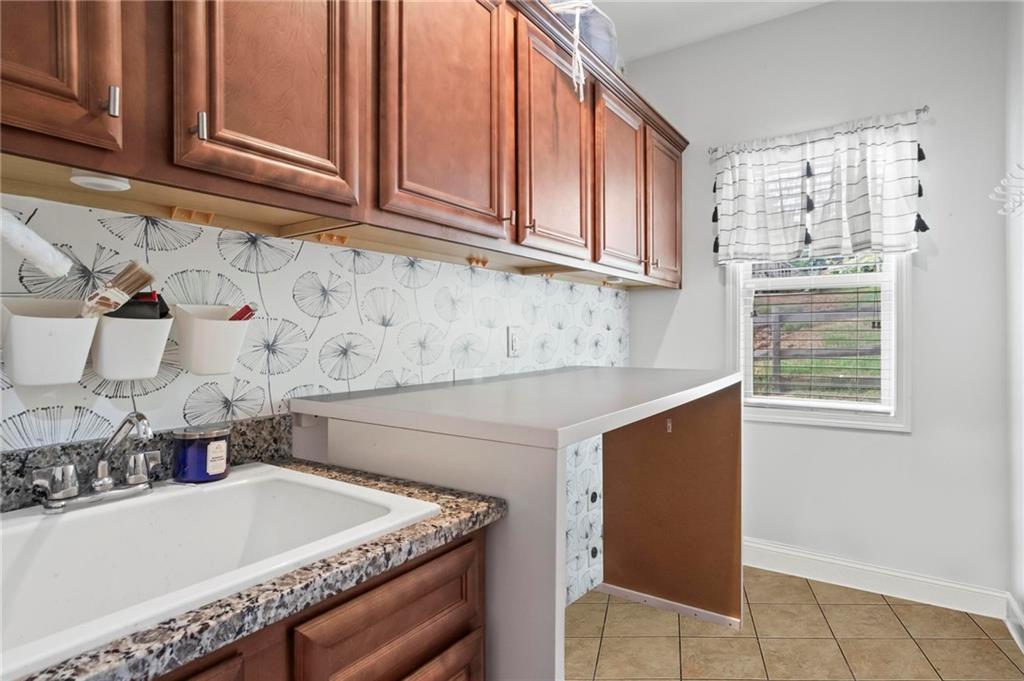 183 Lullwater Lane Dallas, GA 30132 - Photo 31 of 40 a kitchen with stainless steel appliances granite countertop a sink and a white cabinets