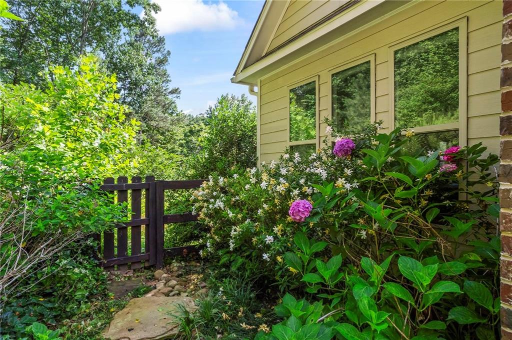 183 Lullwater Lane Dallas, GA 30132 - Photo 36 of 40 a flower garden is sitting in front of a house