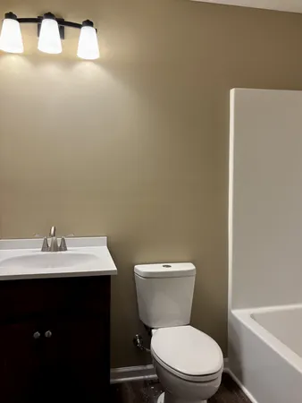 a bathroom with a toilet a sink and bathtub
