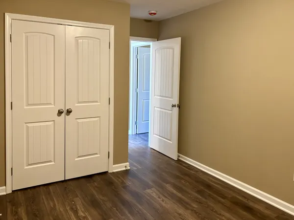 an empty room with wooden floor