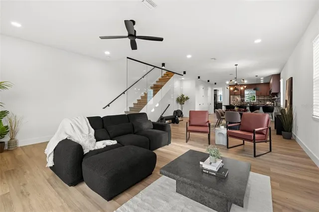 a living room with furniture and a wooden floor