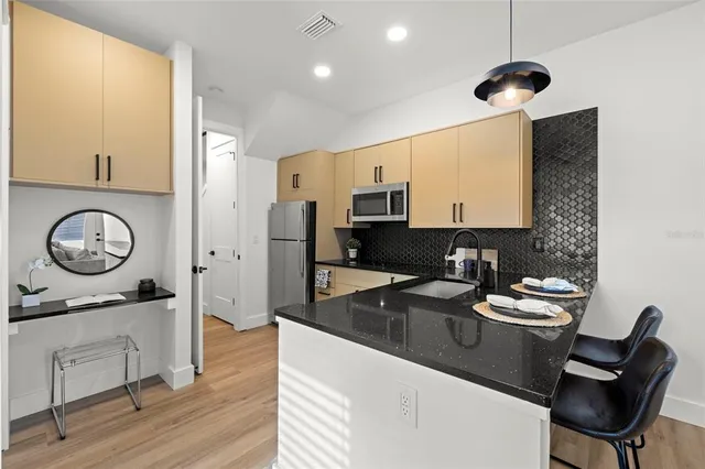 a kitchen with a sink appliances and cabinets