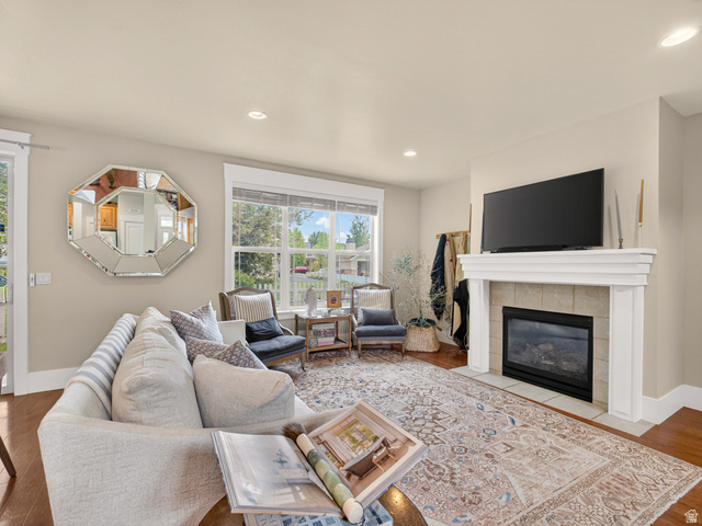 557 Craftsman Way Midway, UT 84049 - Photo 11 of 59 Living area featuring a fireplace with a white mantel, tile surround, and a gas insert