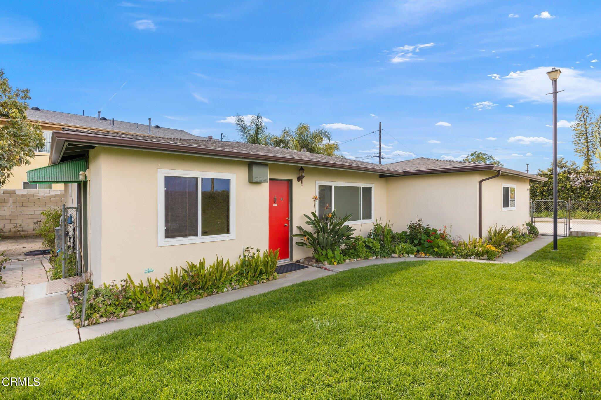 4989 Strickland Drive Oxnard, CA 93036 - Photo 1 of 26 a front view of a house with garden
