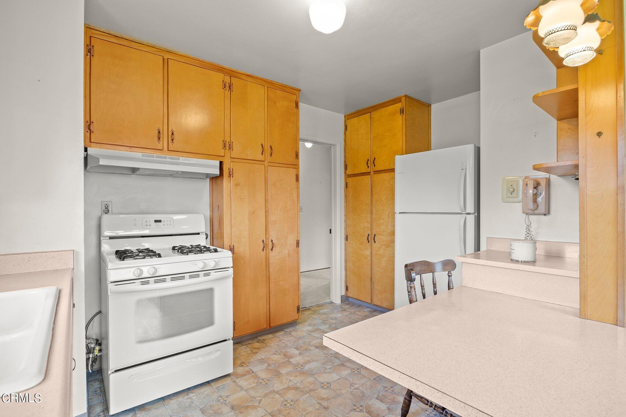 4989 Strickland Drive Oxnard, CA 93036 - Photo 11 of 26 a kitchen with a stove a refrigerator and a stove