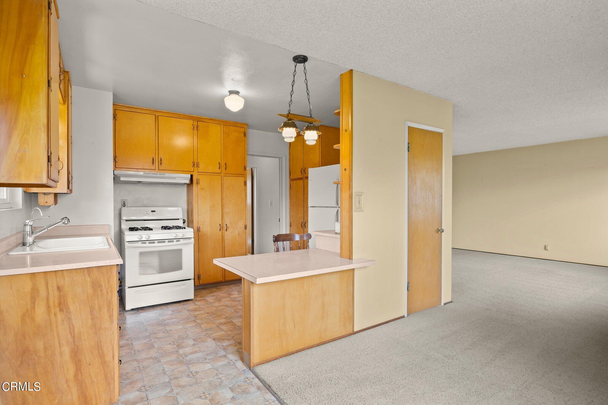 4989 Strickland Drive Oxnard, CA 93036 - Photo 13 of 26 a room with a bed a stove and a window