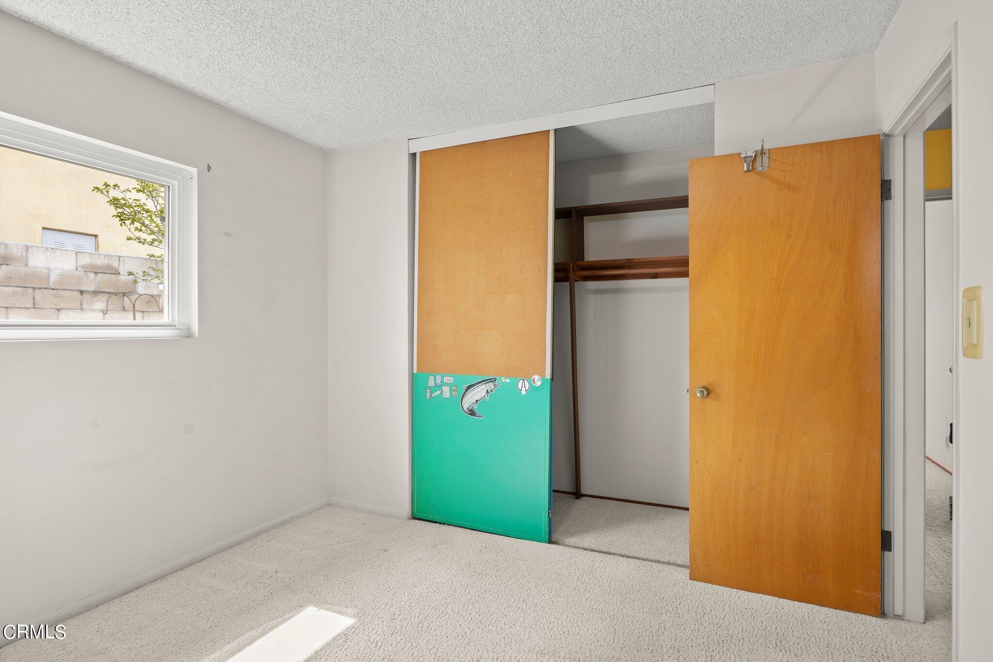 4989 Strickland Drive Oxnard, CA 93036 - Photo 17 of 26 a kitchen with a refrigerator and painted walls