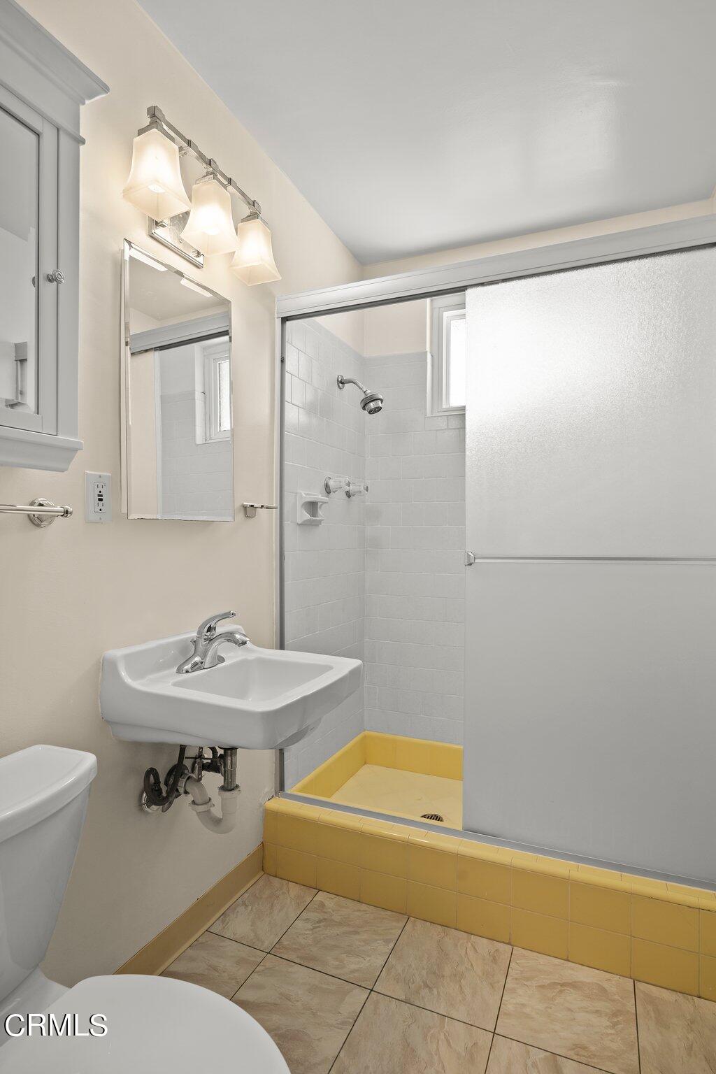 4989 Strickland Drive Oxnard, CA 93036 - Photo 19 of 26 a bathroom with a sink mirror vanity and toilet