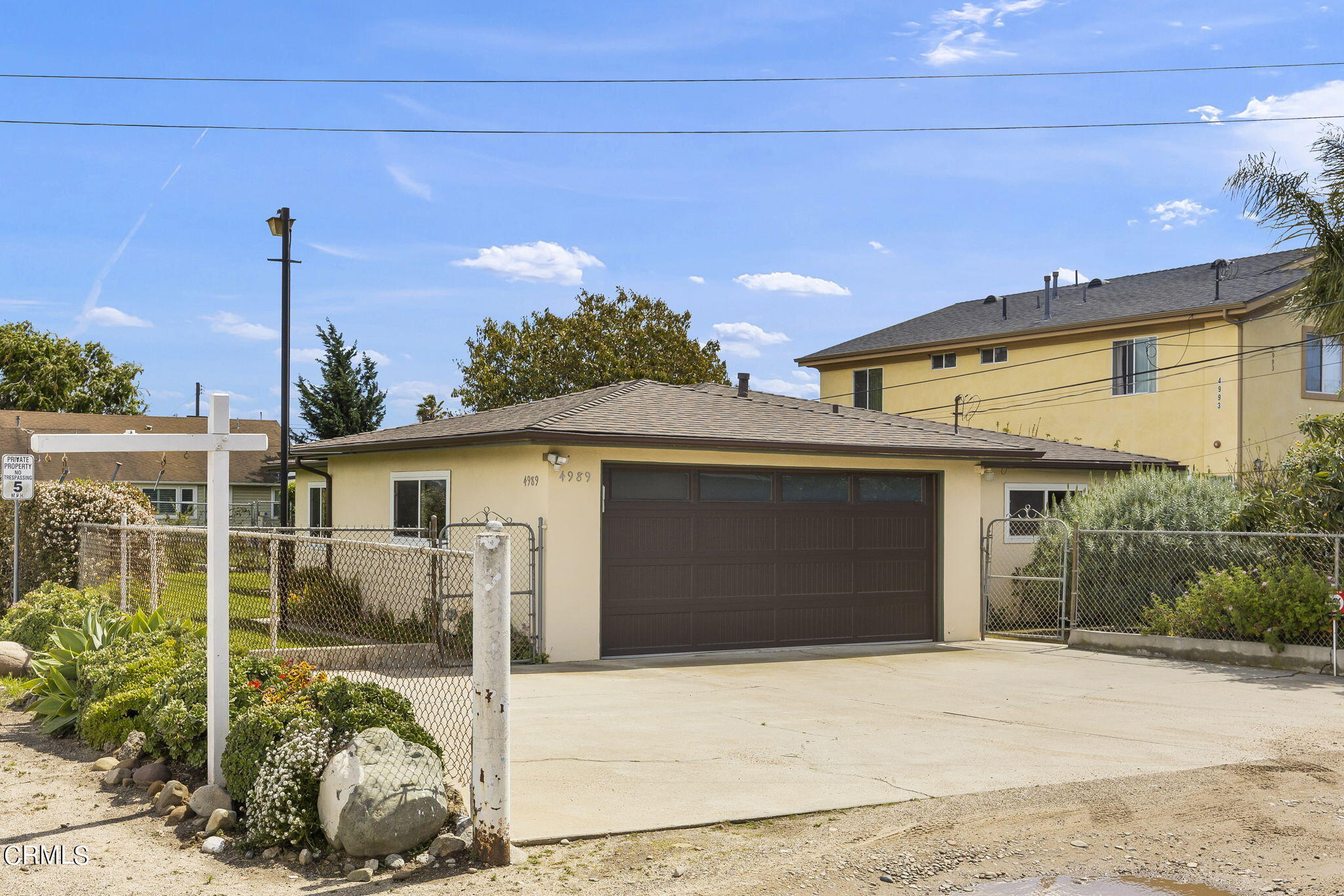 4989 Strickland Drive Oxnard, CA 93036 - Photo 5 of 26 a front view of a house with a garden