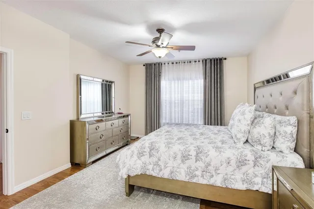 a bedroom with a large bed and a chandelier