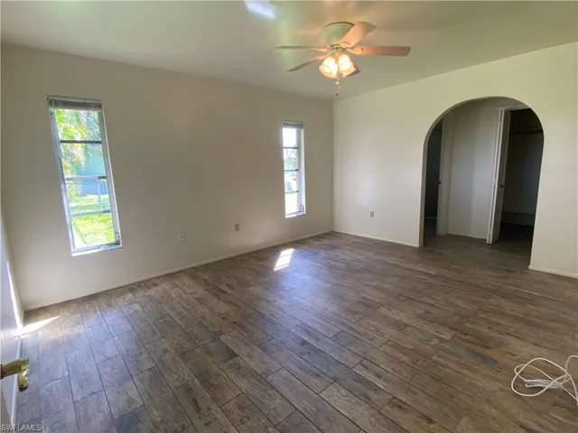 a view of a room with wooden floor and a bathroom view