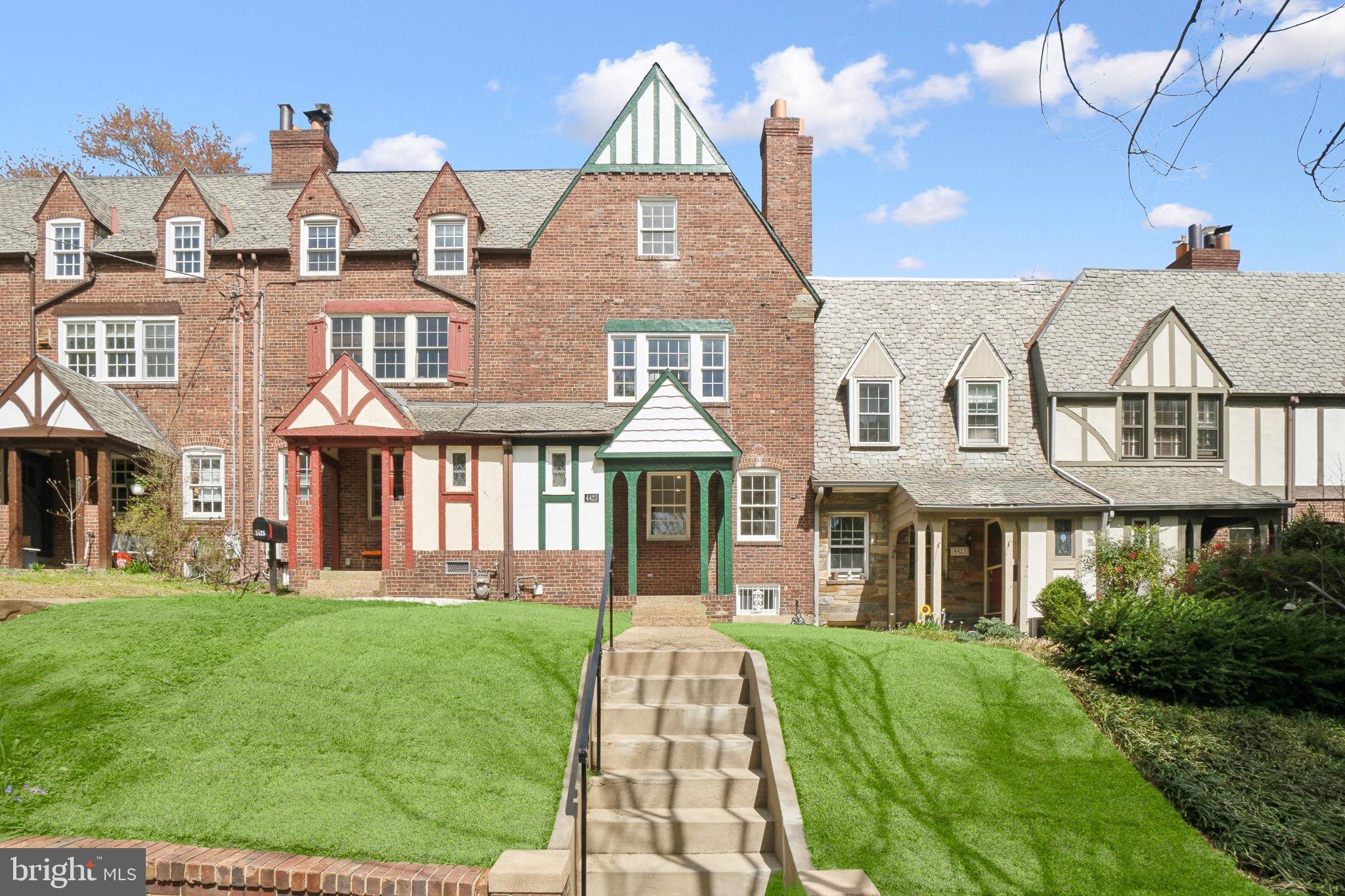 a front view of a residential apartment building with a yard