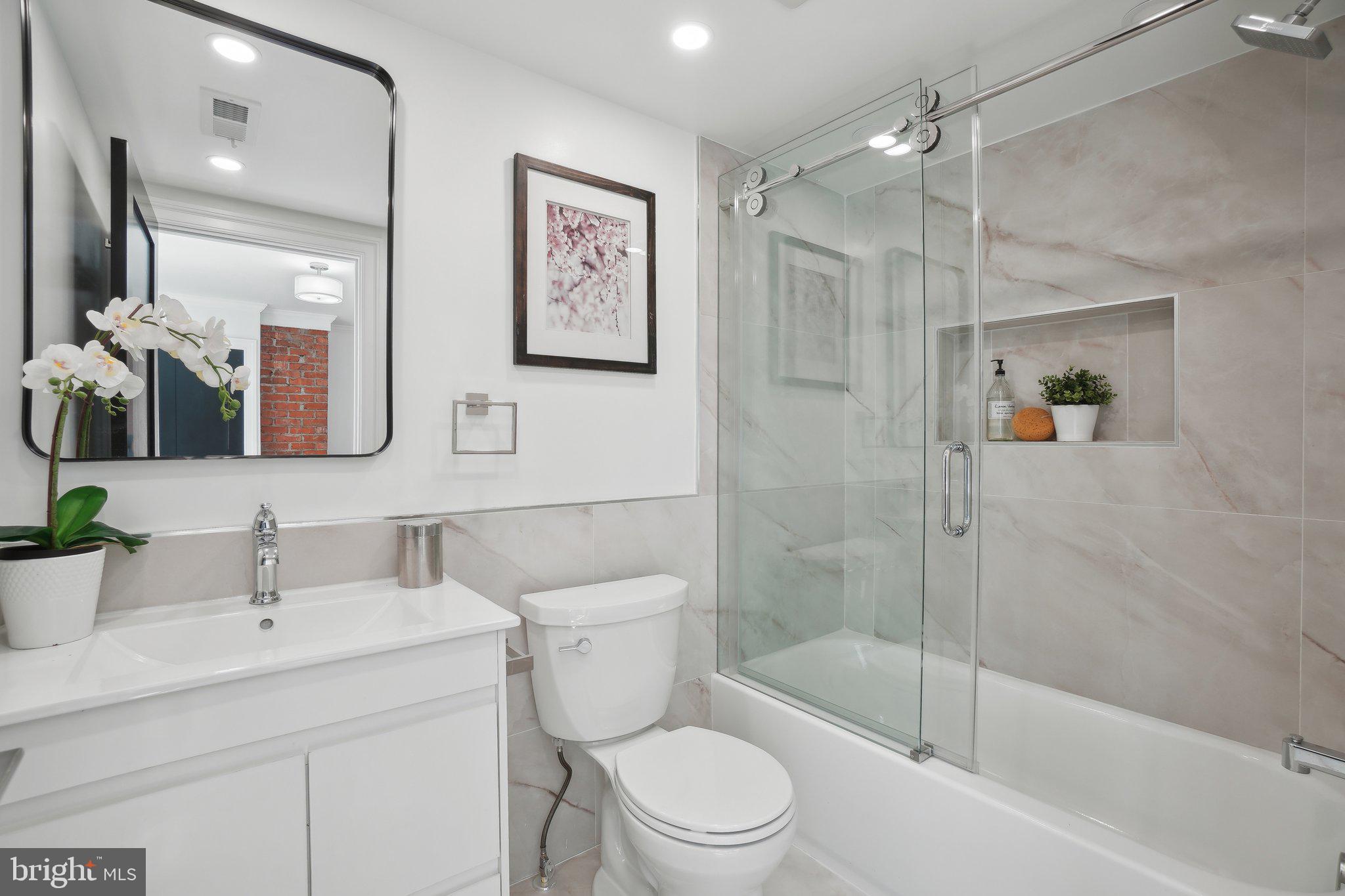 4423 Volta Place Northwest Washington, DC 20007 - Photo 18 of 36 a bathroom with a toilet sink and shower