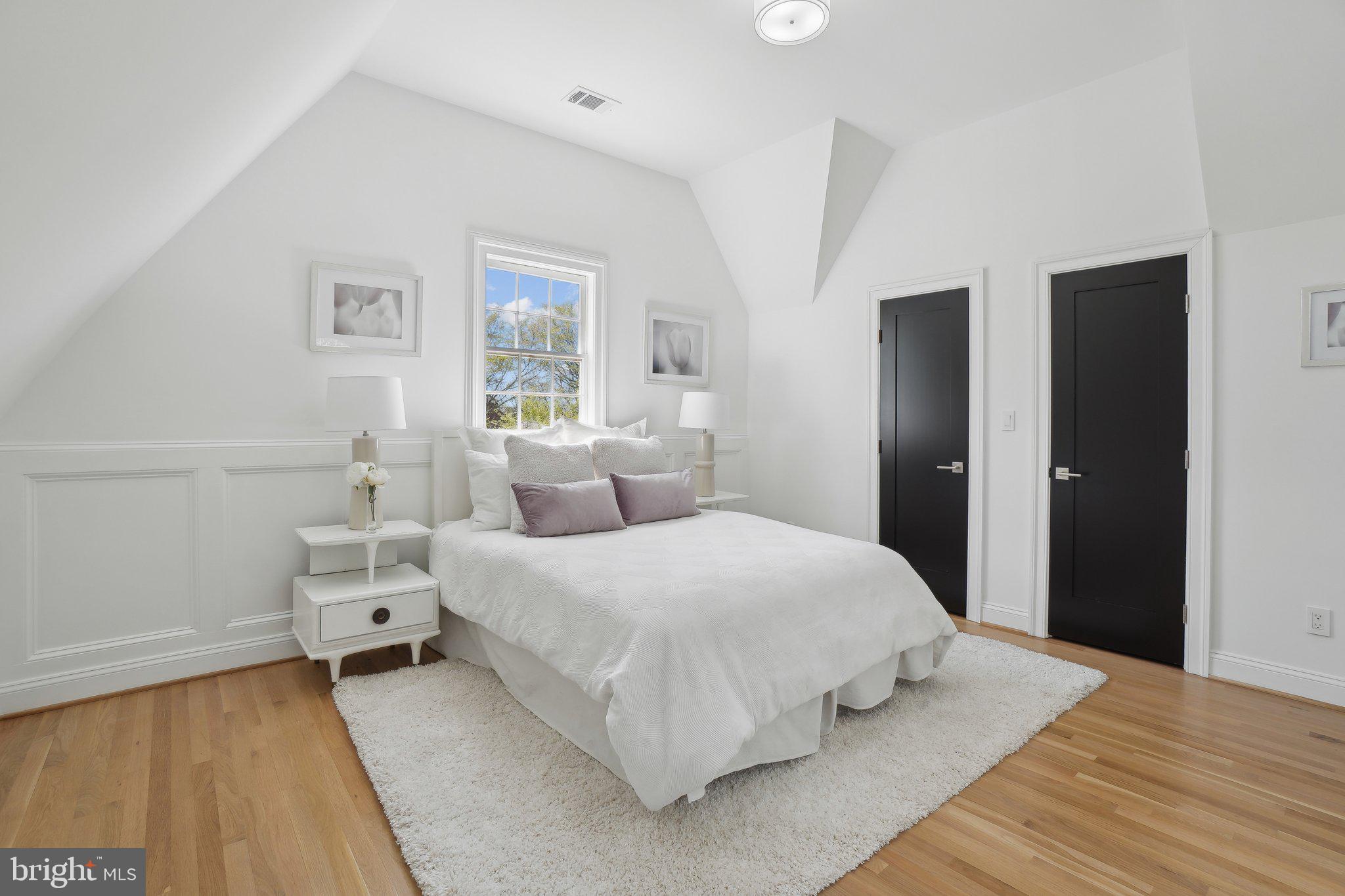 4423 Volta Place Northwest Washington, DC 20007 - Photo 19 of 36 a bedroom with a bed and wooden floor