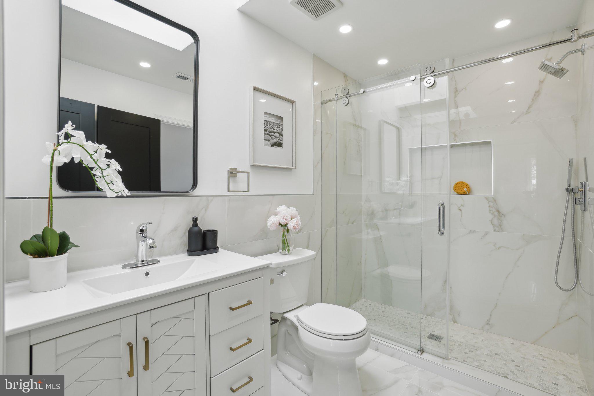 4423 Volta Place Northwest Washington, DC 20007 - Photo 21 of 36 a bathroom with a sink a toilet and shower