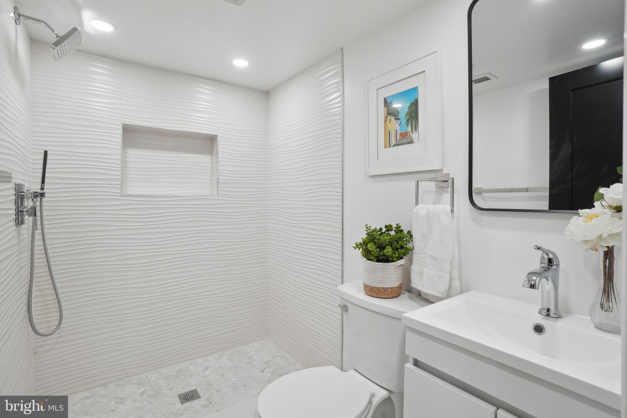 4423 Volta Place Northwest Washington, DC 20007 - Photo 28 of 36 a bathroom with a sink toilet and shower