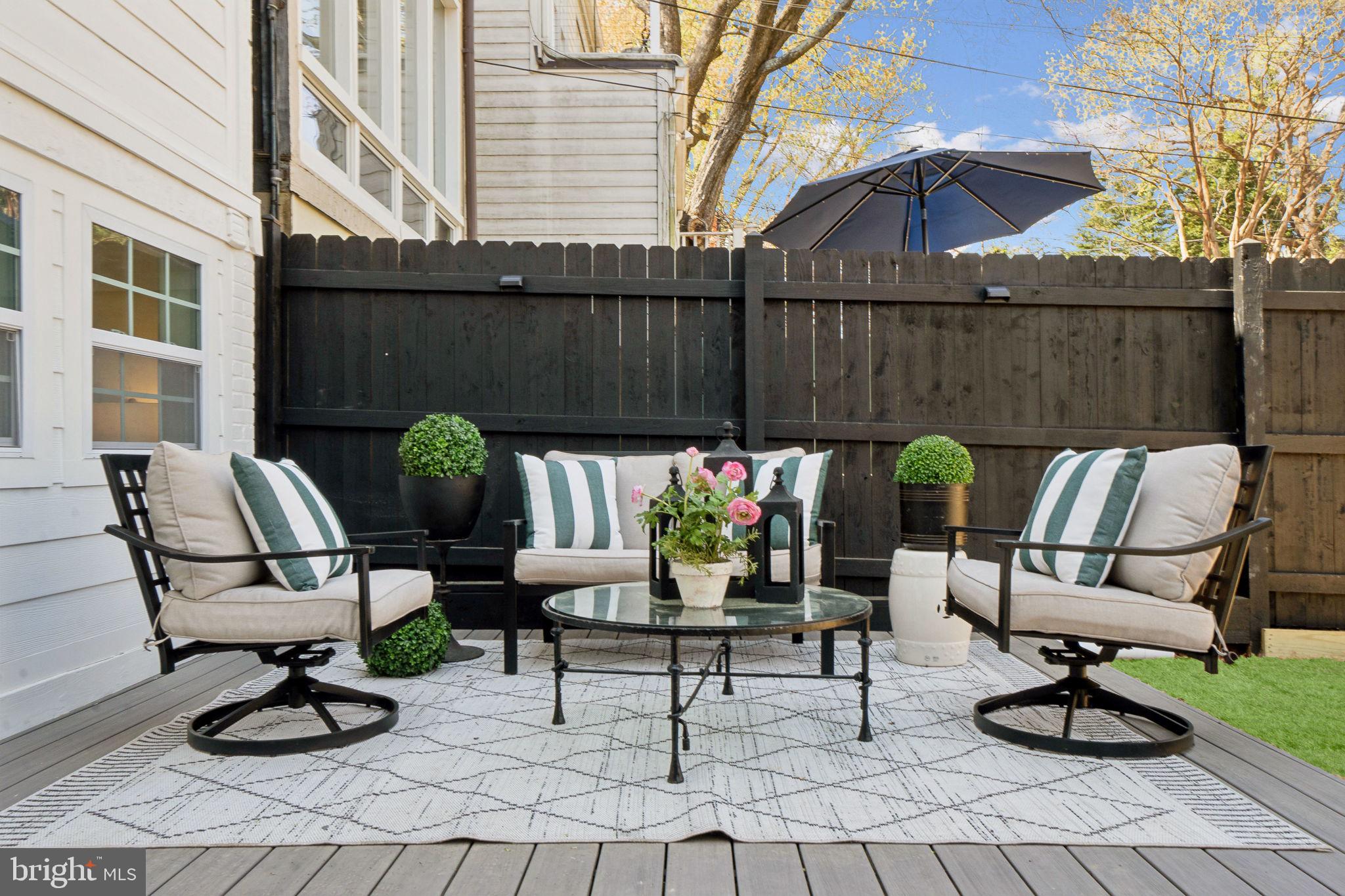 4423 Volta Place Northwest Washington, DC 20007 - Photo 30 of 36 a view of a chairs and tables in the back yard of the house
