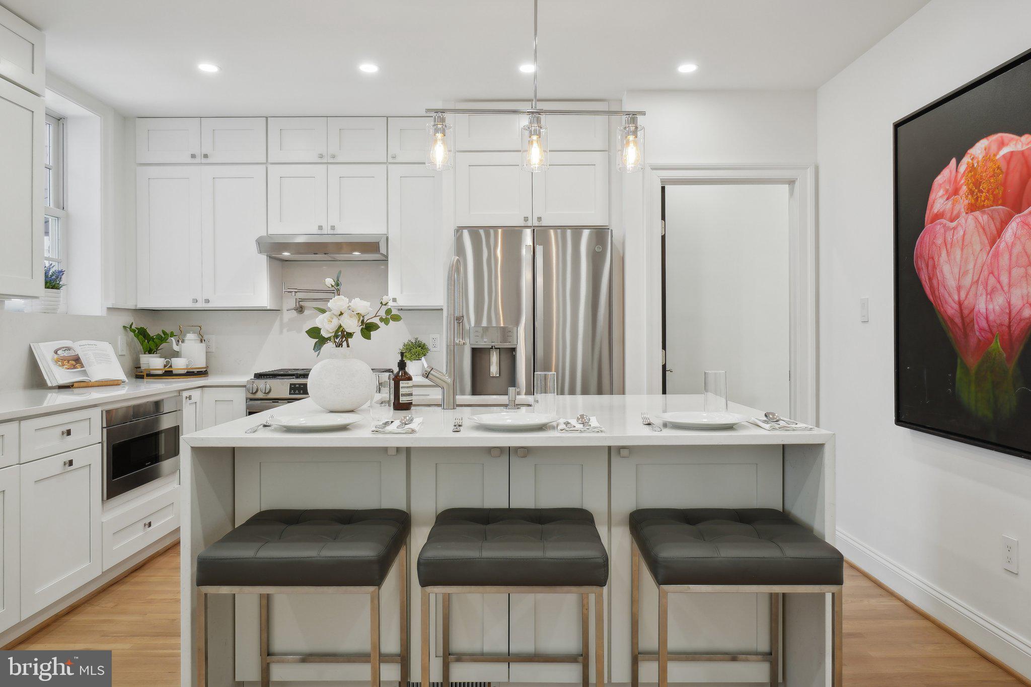 4423 Volta Place Northwest Washington, DC 20007 - Photo 7 of 36 a kitchen with stainless steel appliances a sink and cabinets