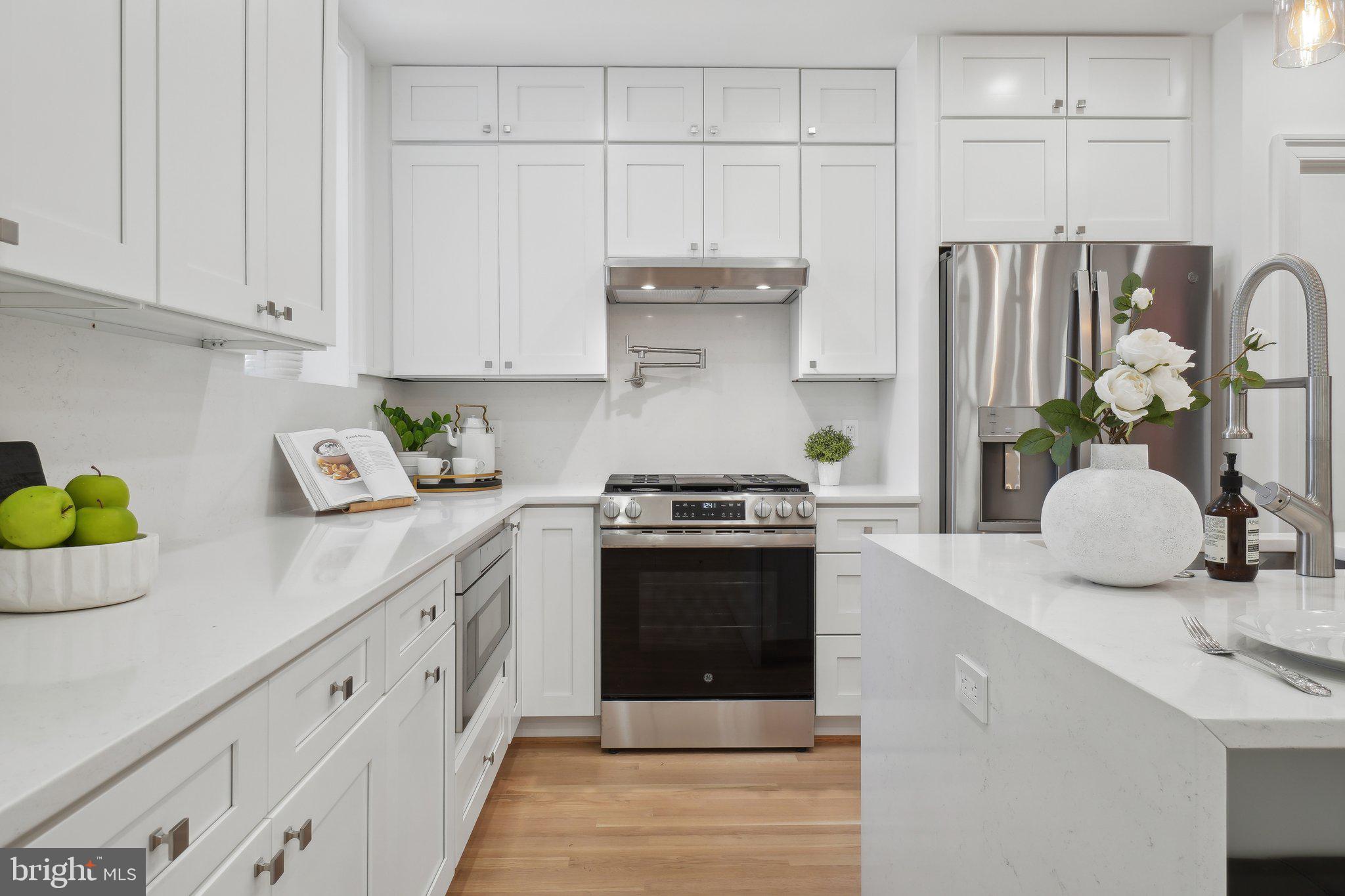 4423 Volta Place Northwest Washington, DC 20007 - Photo 8 of 36 a kitchen with stainless steel appliances granite countertop a sink stove and cabinets