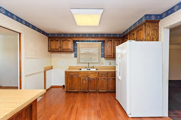 a kitchen with stainless steel appliances granite countertop a refrigerator and a sink