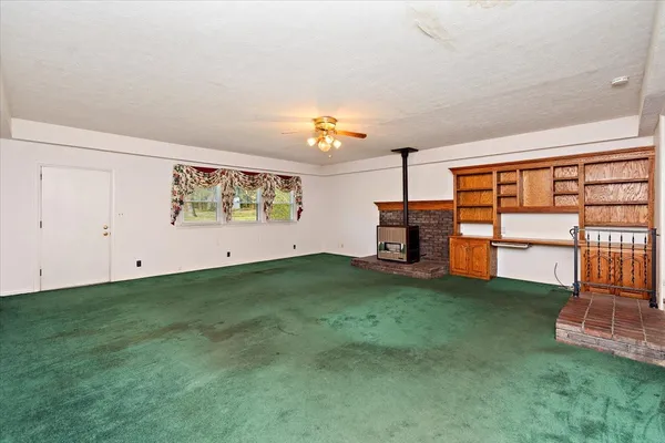 a view of an empty room with a fireplace