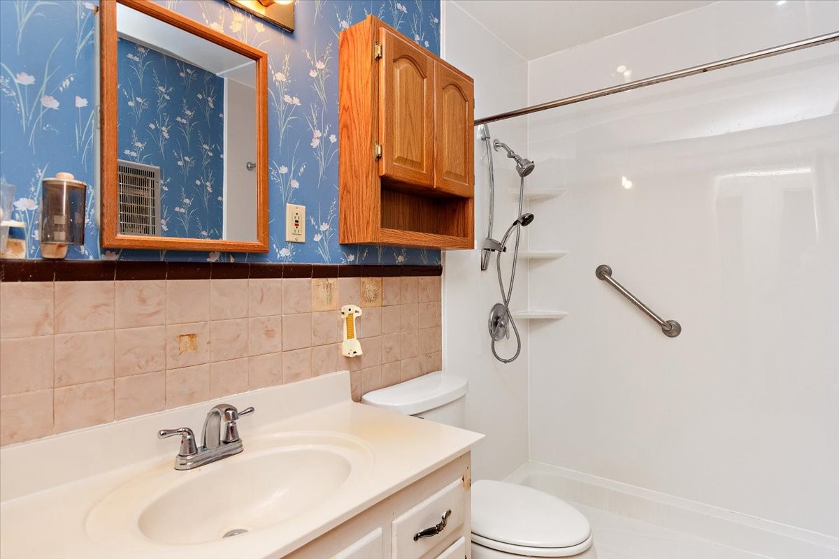 1077 Slaters Creek Road Goodlettsville, TN 37072 - Photo 20 of 29 a bathroom with a sink a toilet and a mirror