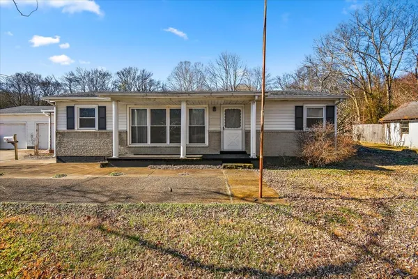 a house that has a tree in front of it