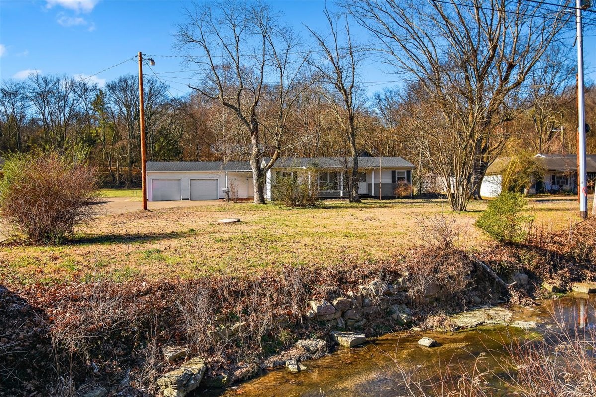 1077 Slaters Creek Road Goodlettsville, TN 37072 - Photo 28 of 29 a view of a yard with trees in front of house