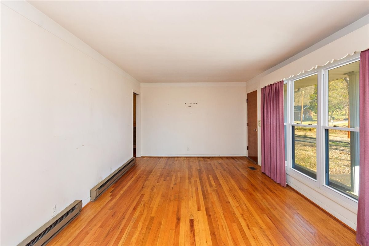1077 Slaters Creek Road Goodlettsville, TN 37072 - Photo 7 of 29 a view of empty room with wooden floor and fan