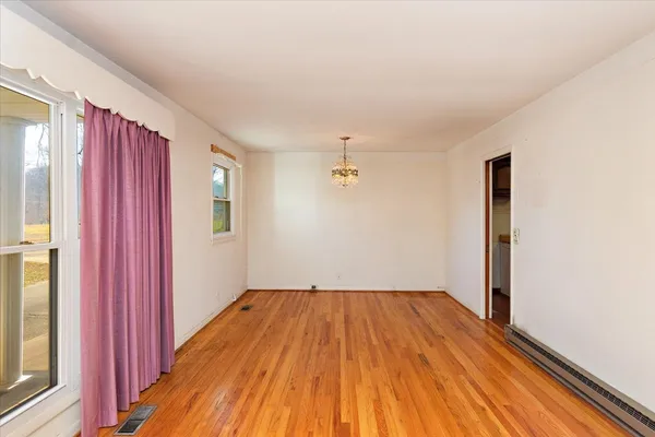 an empty room with wooden floor