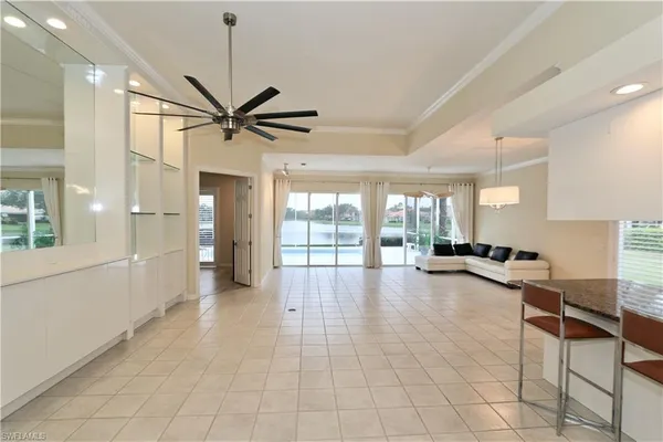 a view of a livingroom with furniture a ceiling fan and a window