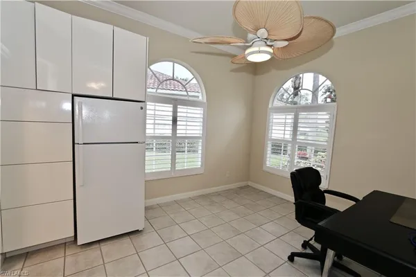 a view of a workspace with furniture and a window