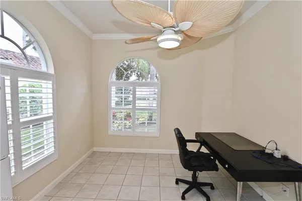 a large white kitchen with a large window and stainless steel appliances