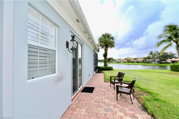 a view of a backyard with swimming pool and furniture