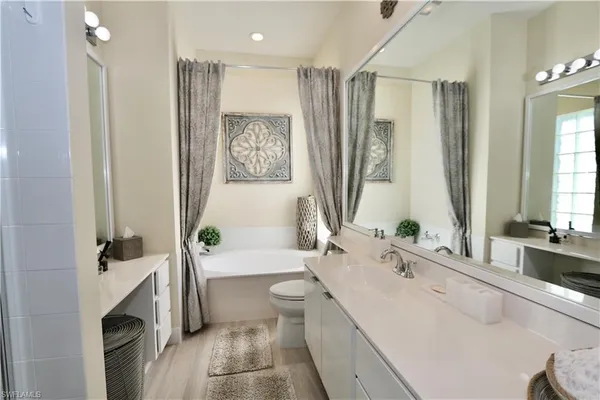 a spacious bathroom with a bathtub sink and toilet