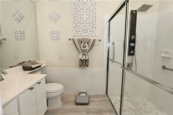 a bathroom with a toilet sink and shower