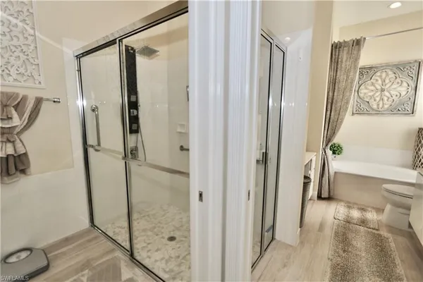 a bathroom with a shower and a tub