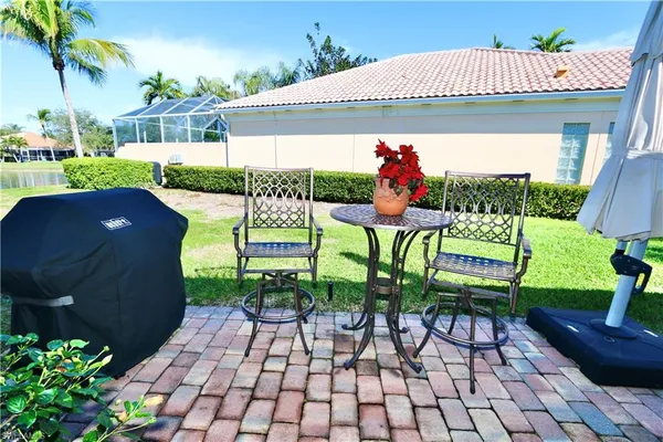 a view of an chairs and table in the patio