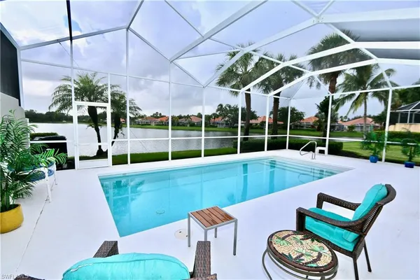 a living room with furniture and large windows