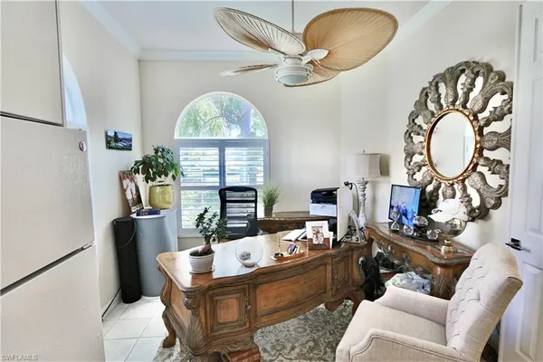 a work room with furniture and a large window