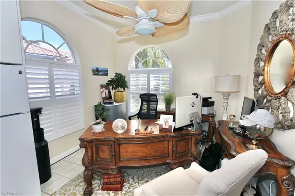 a living room with furniture a window and flowerpot