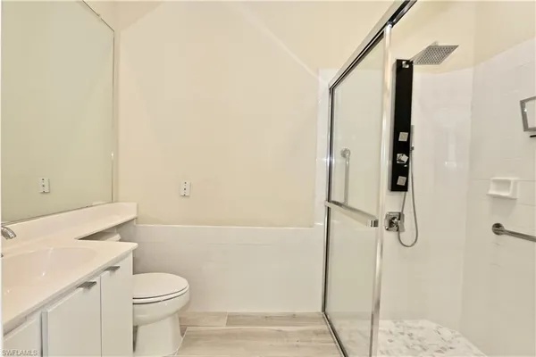 a bathroom with a sink mirror toilet and bathtub