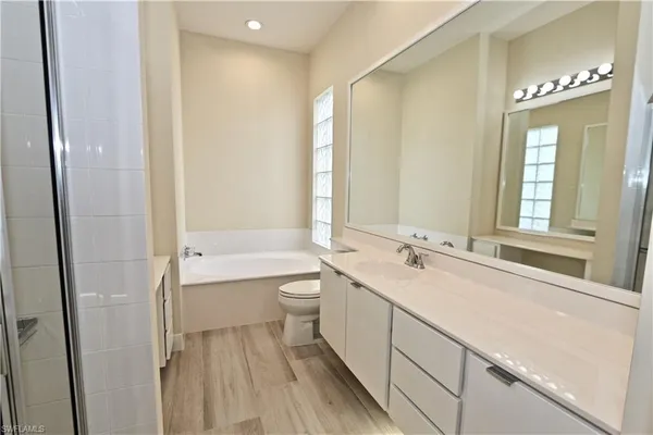 a kitchen with granite countertop a sink a counter top space stainless steel appliances and cabinets