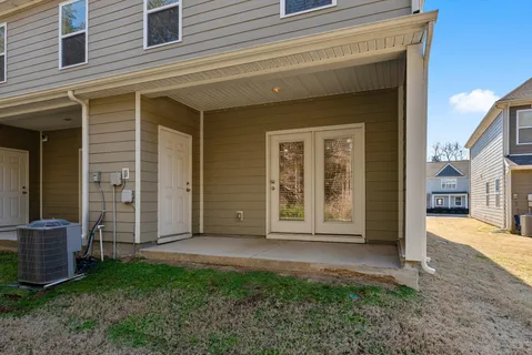 a view of a house with backyard and porch