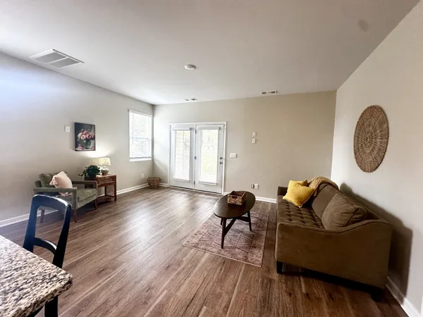 a living room with furniture rug and wooden floor
