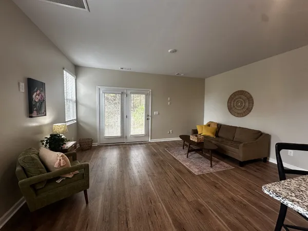 a living room with furniture and wooden floor