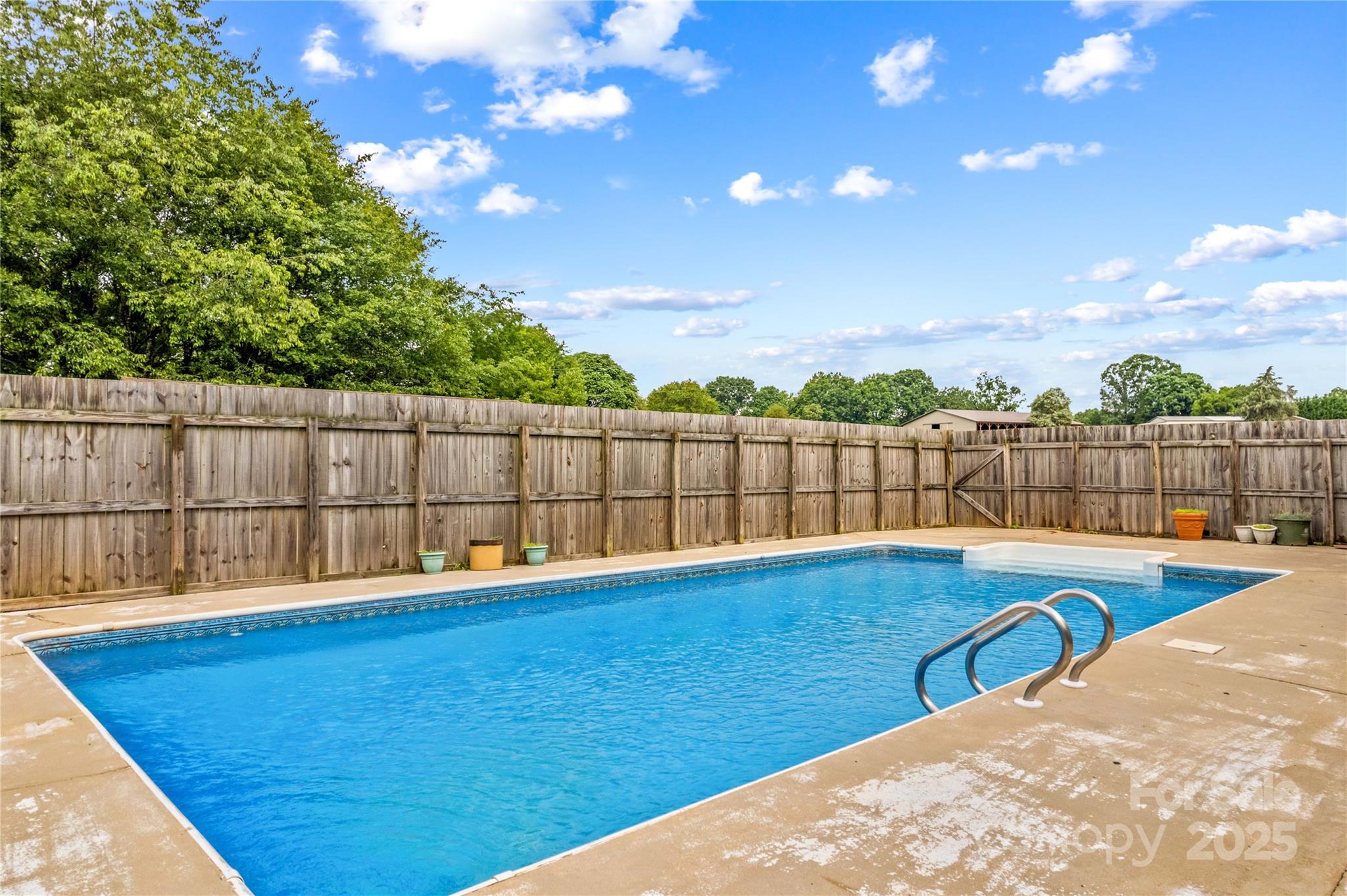 296 Hicks Creek Road Troutman, NC 28166 - Photo 25 of 48 a view of a backyard with a swimming pool