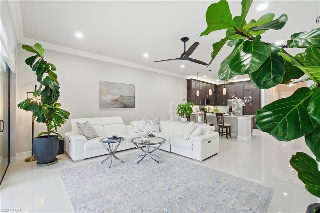 4318 Aurora Street Naples, FL 34119 - Photo 18 of 50 Living area featuring crown molding, a ceiling fan, recessed lighting, and light tile patterned floors